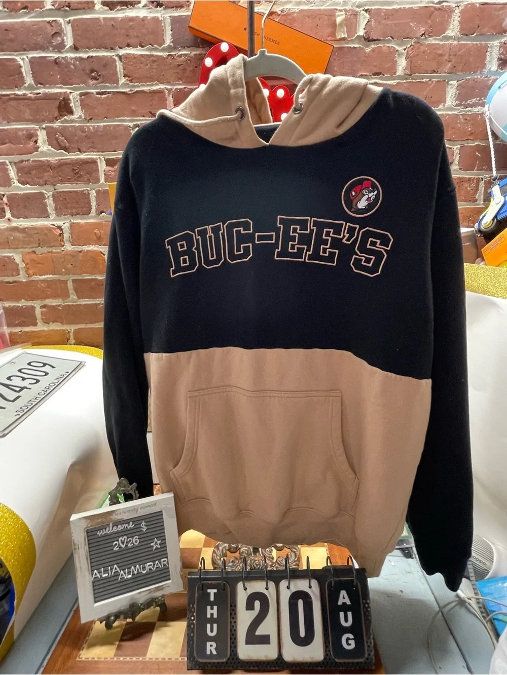 official two-toned black and tan Buc-ee's collegiate pullover hoodie